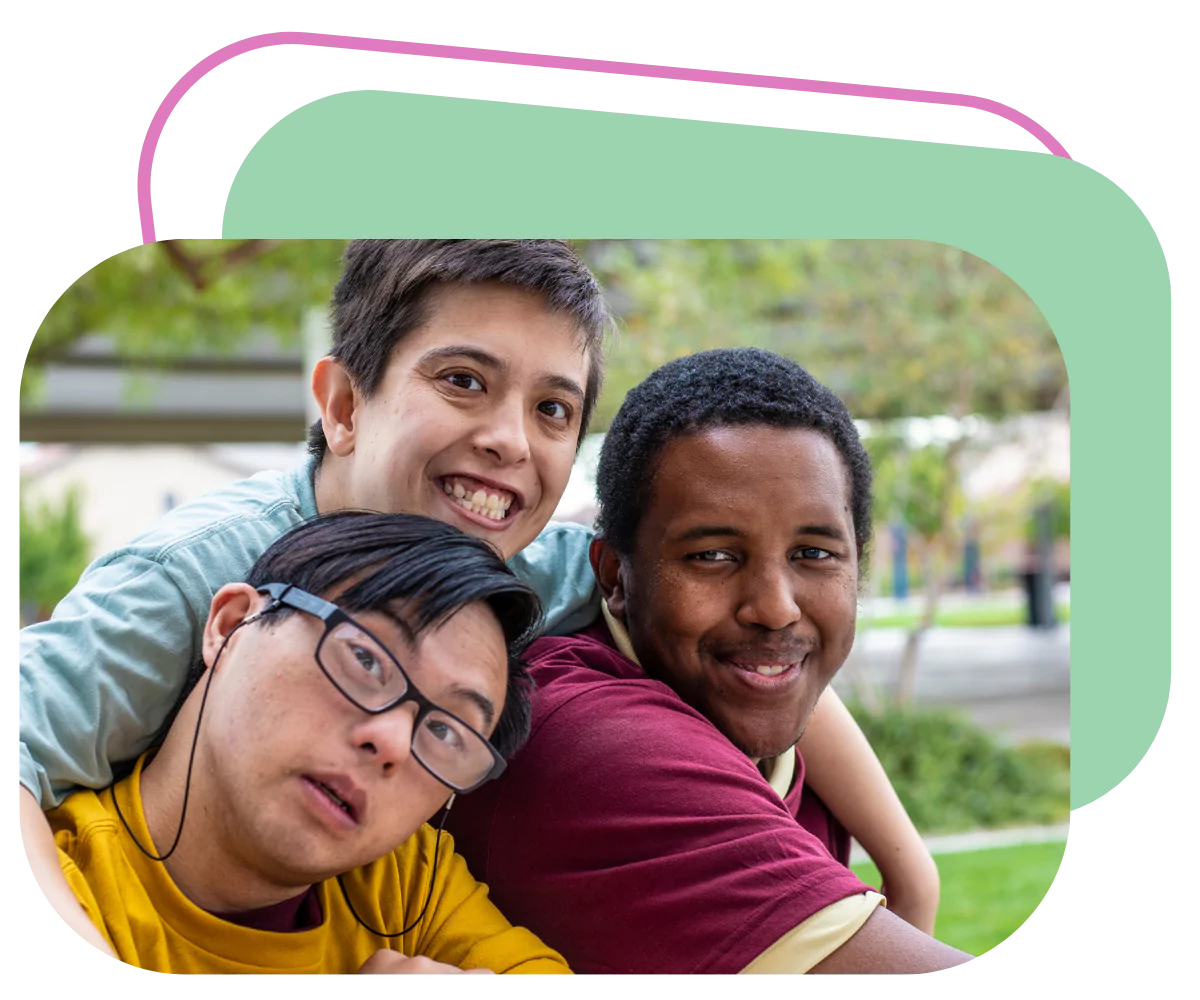 A group of 3 disabled friends are enjoying their time spent together while outdoors at a park