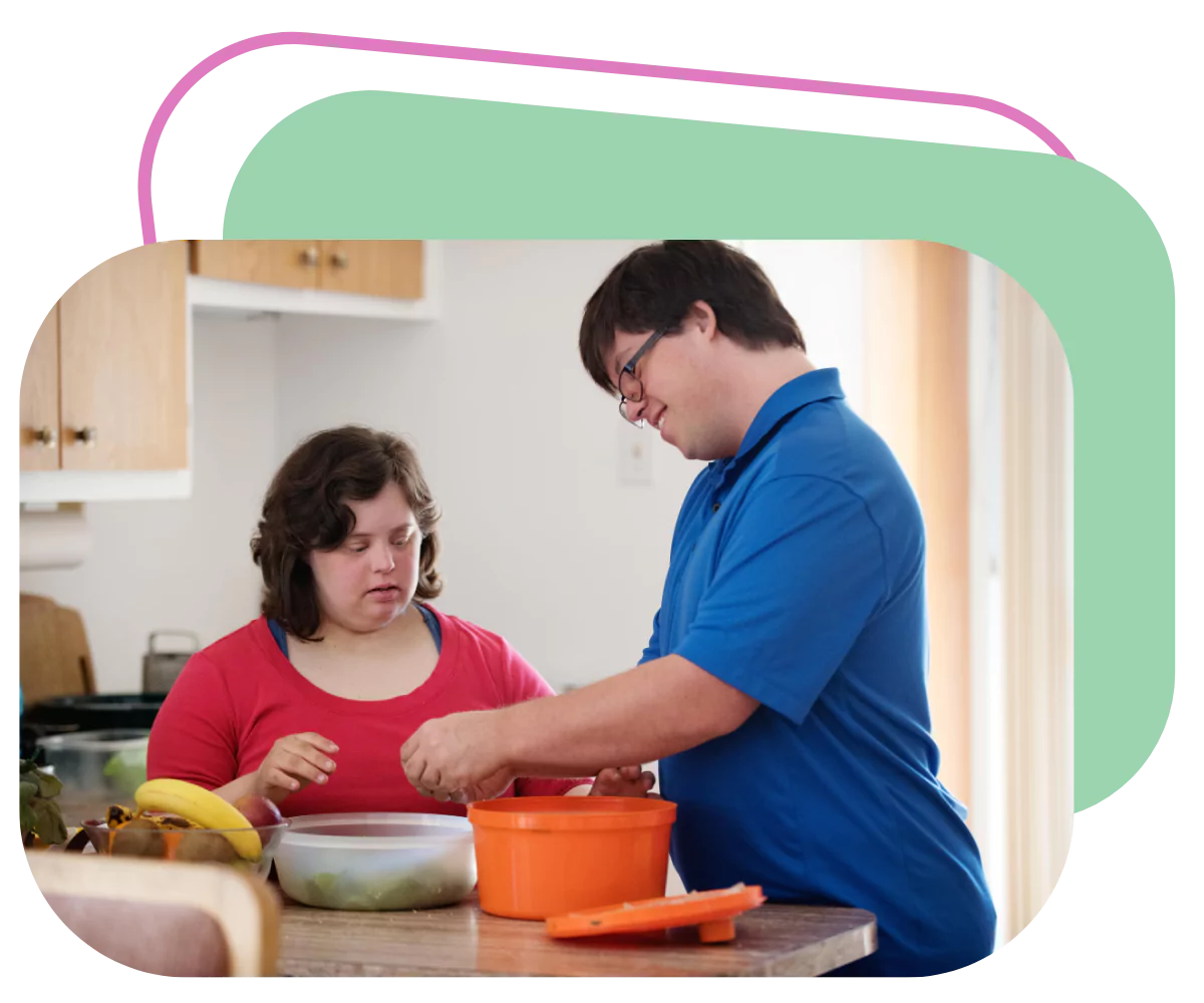 A young man and woman, both with down syndrome are preparing food together in the kitchen